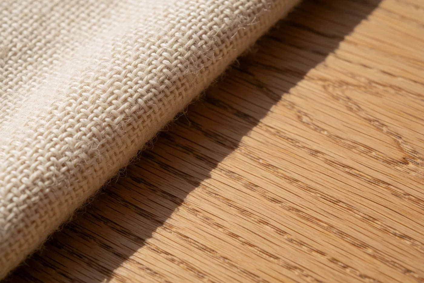 Close detail of oiled oak grain and woven wool